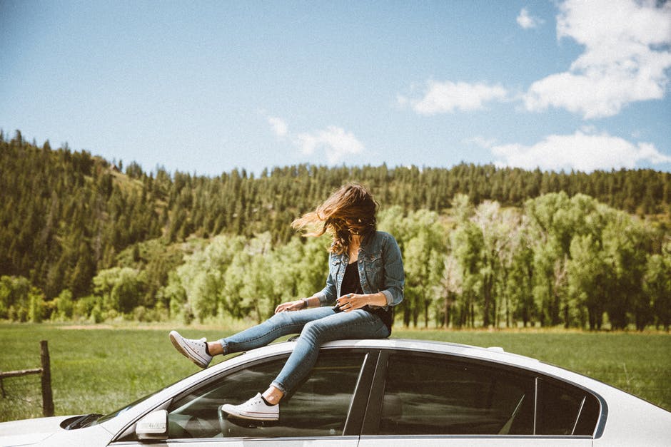 Woman wearing converse sneakers road tripping